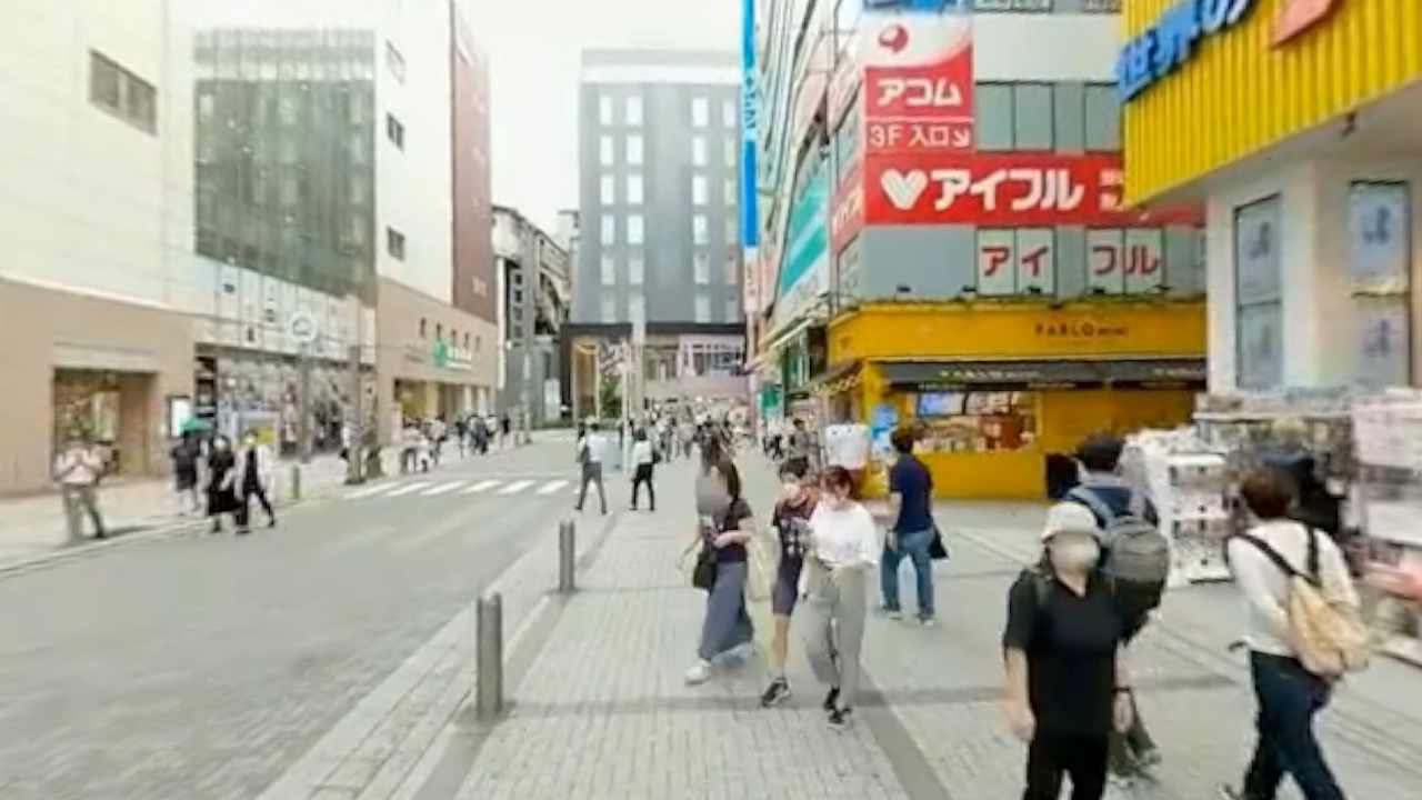 Dense, information-rich Akihabara streetscape from a first-person view.
